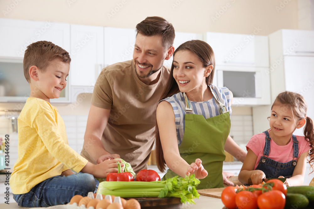 Happy family with children together in kitchen
