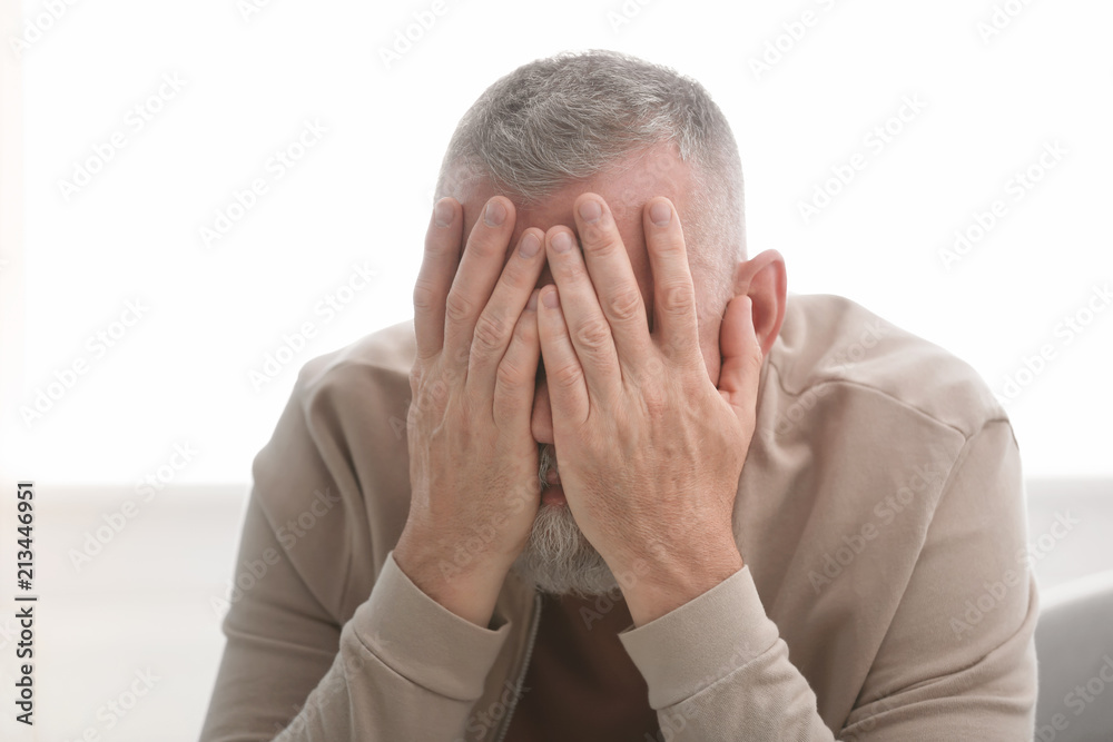 Senior man in state of depression indoors Senior man in state of depression indoors