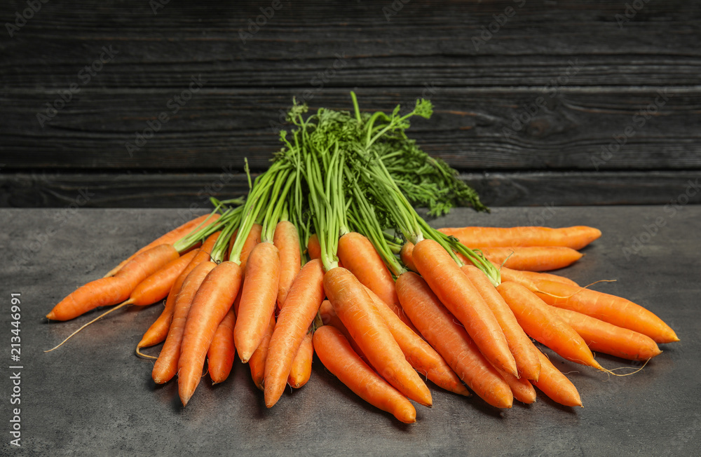 Ripe carrots on grey table. Healthy diet Ripe carrots on grey table. Healthy diet