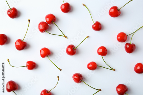 Ripe red cherries on light background, top view
