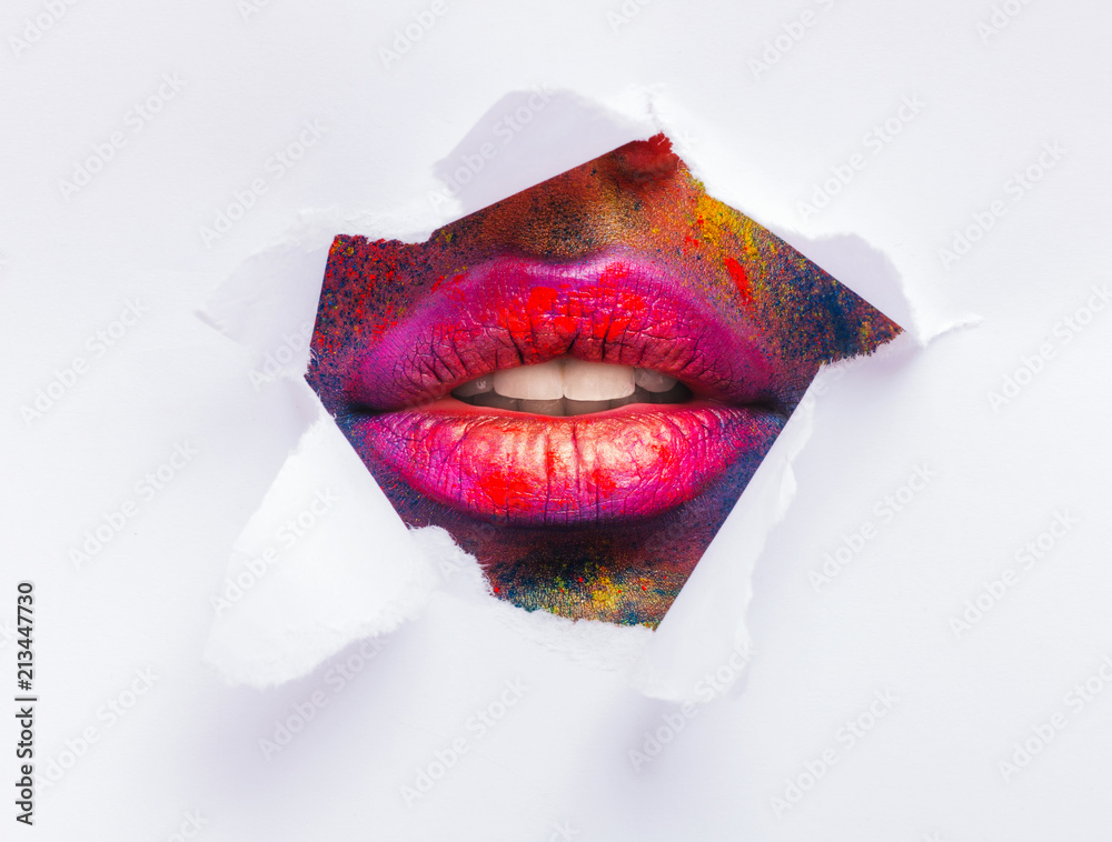 Red lips through torn slot of white paper Stock Photo | Adobe Stock