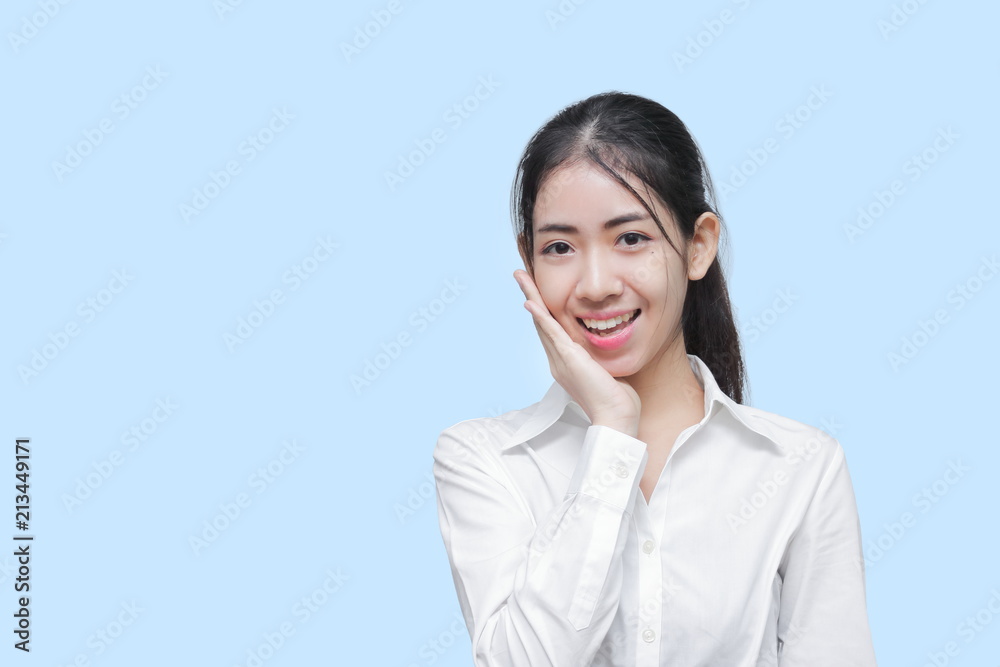 Beauty pretty young Asian woman with hands on face posing on blue isolated background. Beauty pretty young Asian woman with hands on face posing on blue isolated background.