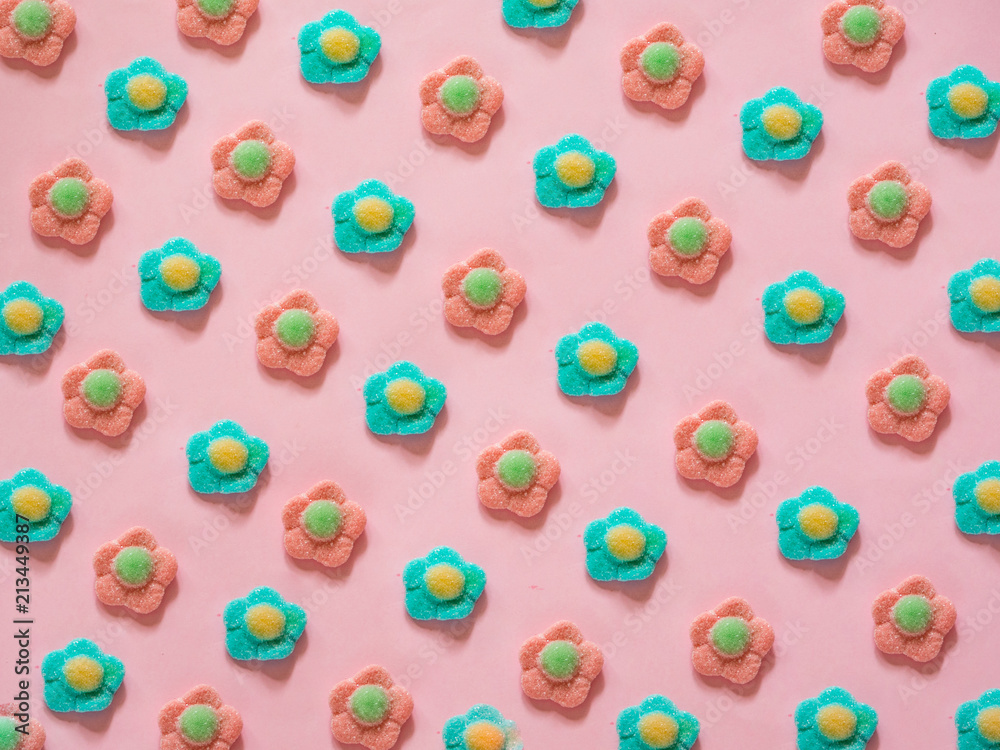 Pink and blue flower jelly candies pattern on pink background Pink and blue flower jelly candies pattern on pink background