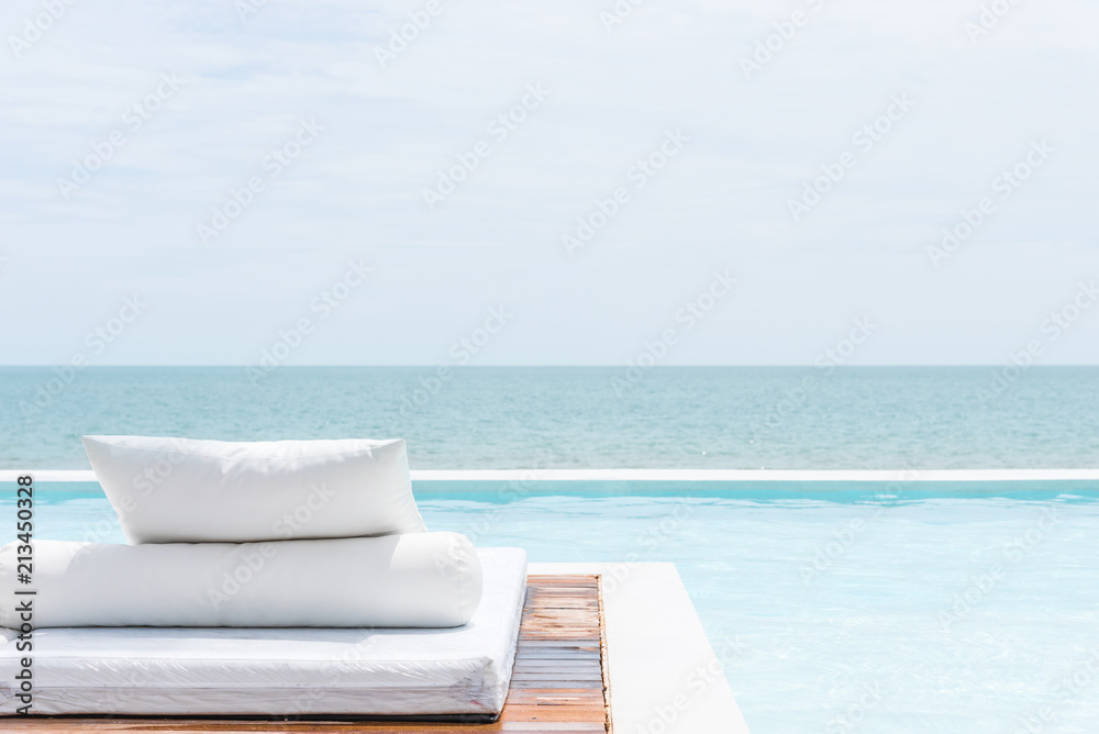 White bed at pool seaside the sea with horizon sky White bed at pool seaside the sea with horizon sky