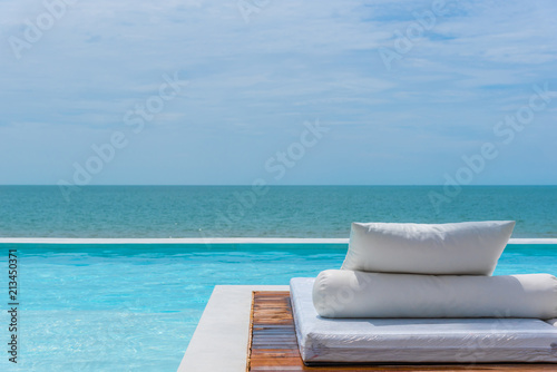 White bed at pool seaside the sea with horizon sky