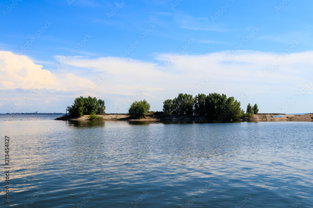 Summer landscape with beautiful lake, green trees and blue sky