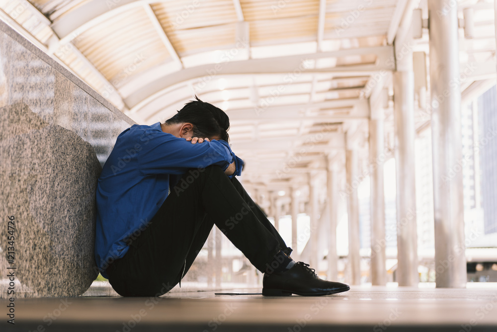 Asian businessman professional failed or upset in his job and sitting on the path. Business problem concept. Asian businessman professional failed or upset in his job and sitting on the path. Business problem concept.