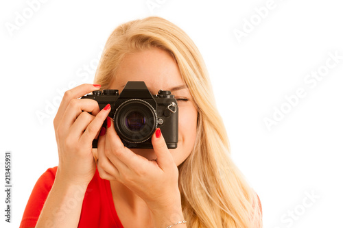 Woman in red with a retro camera isolated over white background