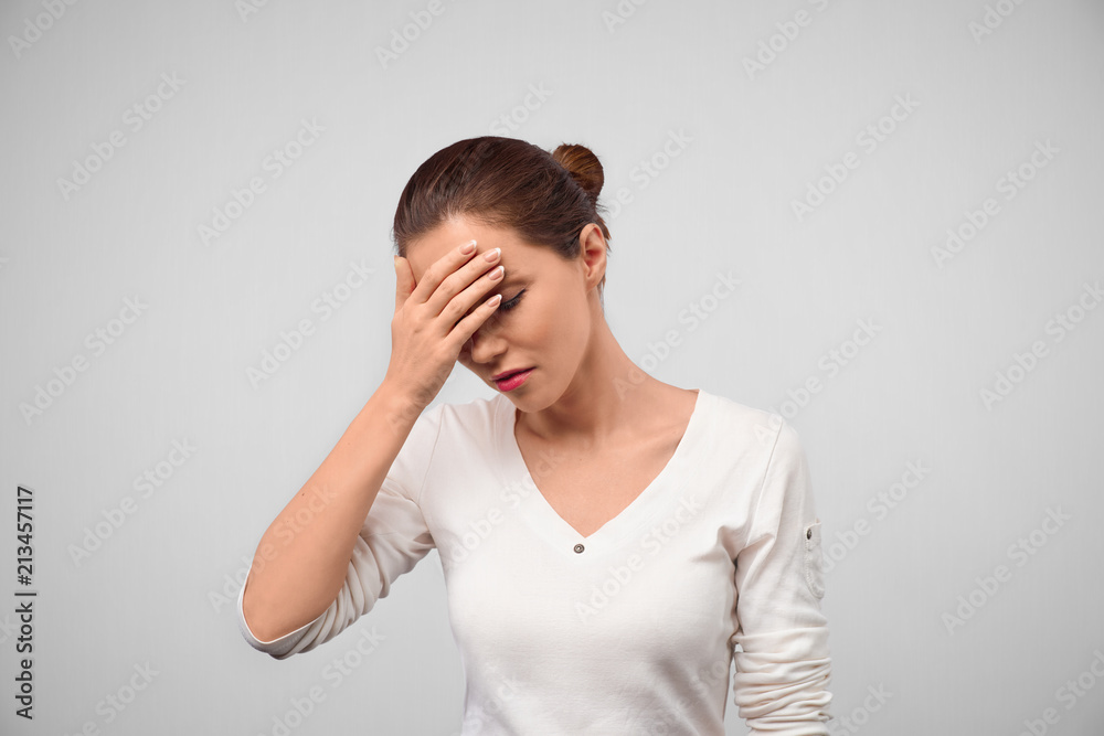 See no evil concept. Portrait of young scared woman covering eyes with hands while standing against gray studio background. Confused girl close eyes with palms ignoring something. Face palm concept See no evil concept. Portrait of young scared woman covering eyes with hands while standing against gray studio background. Confused girl close eyes with palms ignoring something. Face palm concept