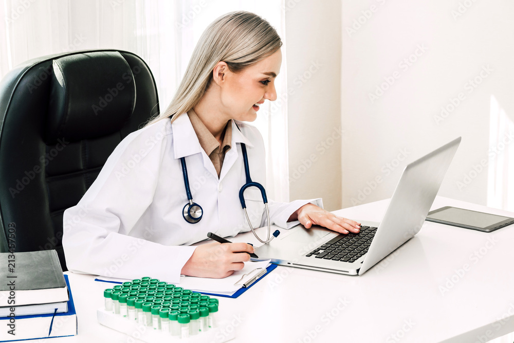 Doctor and stethoscope working with laptop computer in hospital.healthcare and medicine Doctor and stethoscope working with laptop computer in hospital.healthcare and medicine