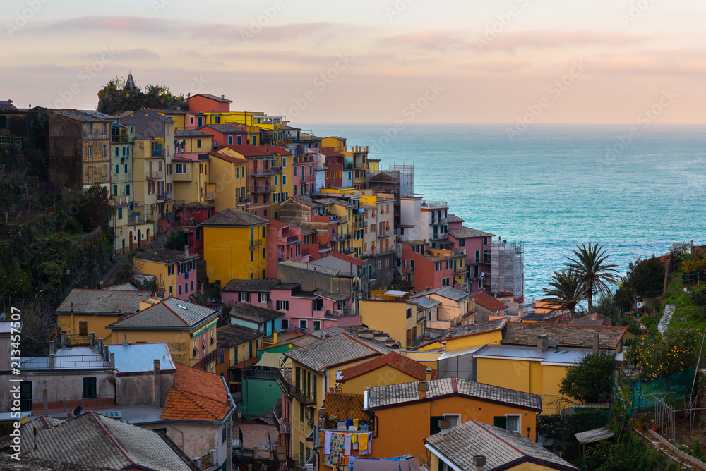 Fototapeta premium Manarola at sunrise, one of colorful villages of Cinque Terre, Italy