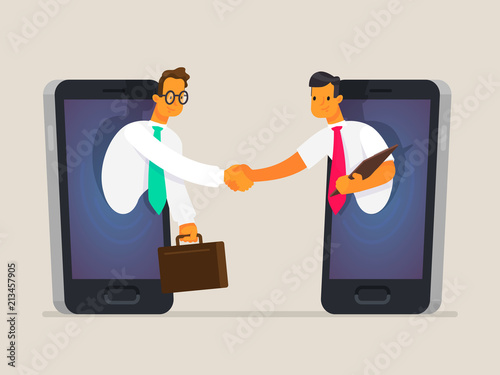 Business people shake hands through the phone screen. The concept of business communications