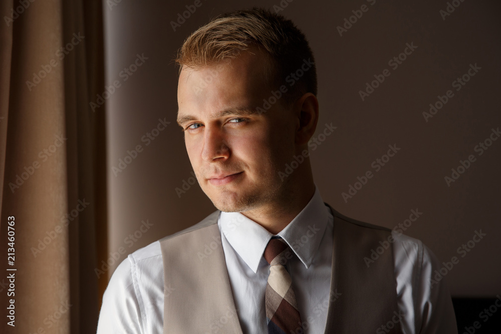 Photo of concentrated man, guy in stylish tuxedo, looking at the camera. Portrait of handsome man, waiting for successful business day Photo of concentrated man, guy in stylish tuxedo, looking at the camera. Portrait of handsome man, waiting for successful business day