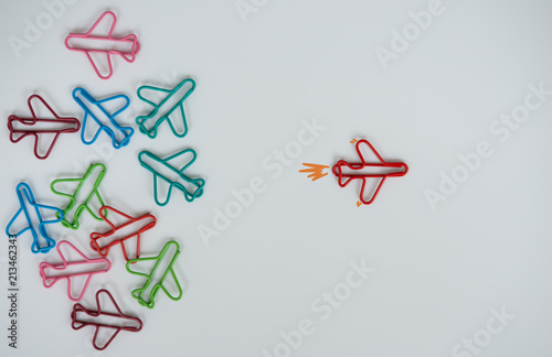 Business concept for group of stacked paperclip with another one red plane paperclip is point to another direction as a team leadership