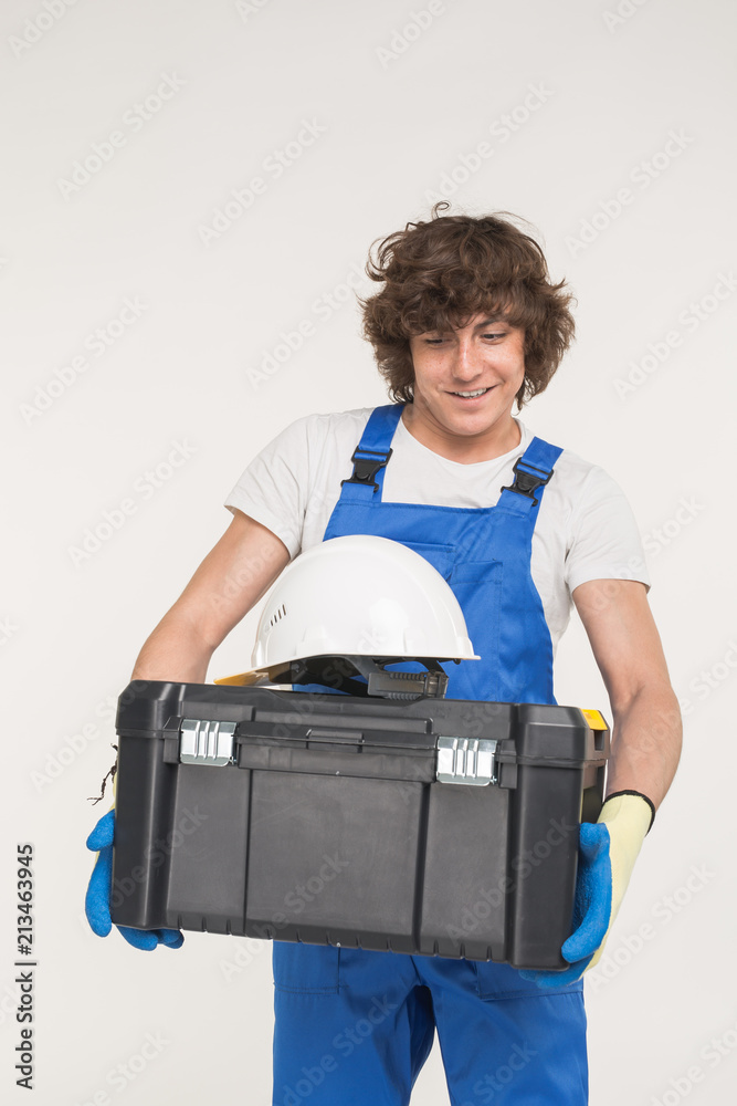 Portrait of handsome caucasian man holding toolbox Portrait of handsome caucasian man holding toolbox