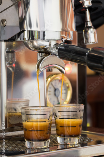 Double shot coffee pouring from Espresso machine. Perfect brewing.