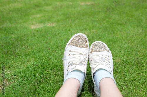 Cute white shoes and green grass , chilling time.