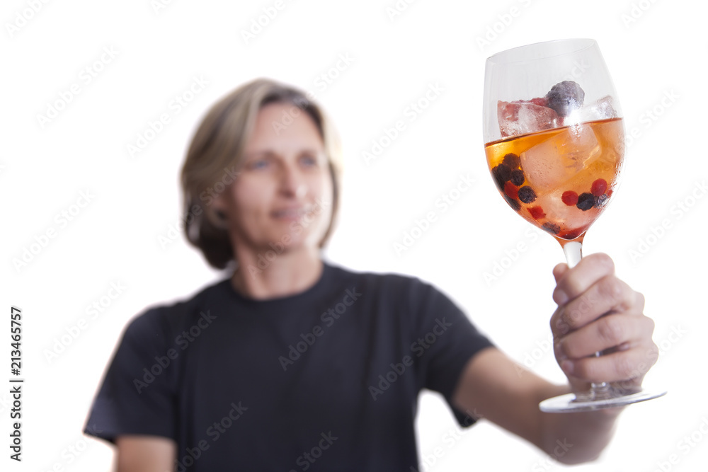 Woman holding a glass with juice, ice and berries. Isolated on white background. Woman holding a glass with juice, ice and berries. Isolated on white background.