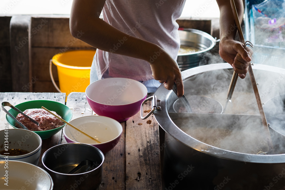 Fototapeta premium Market woman cooking noodle.