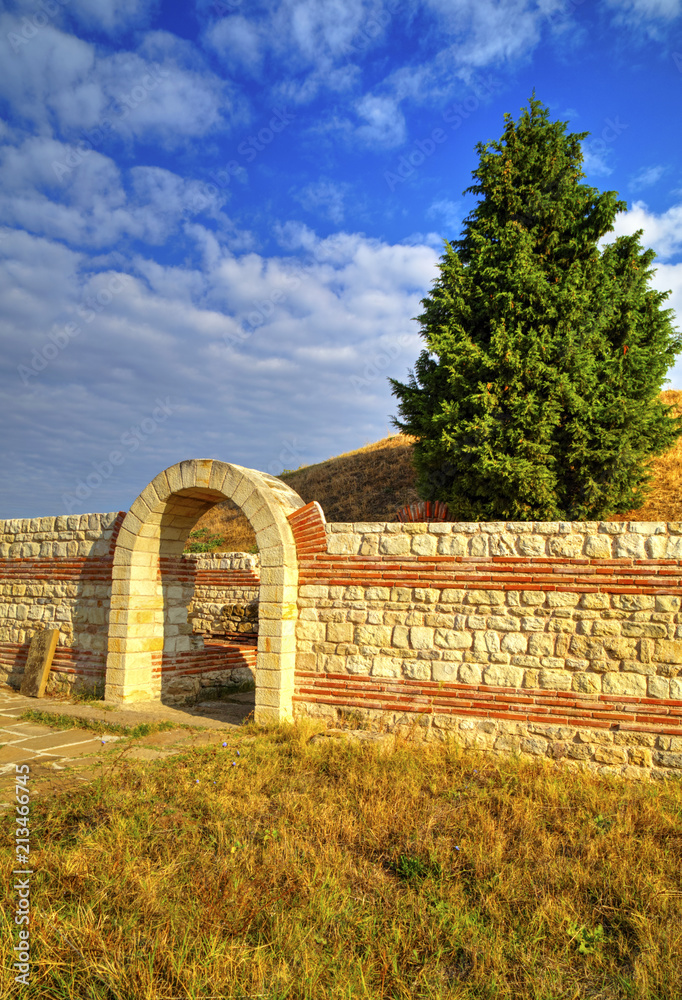 Entrance and stone wall of ancient sanctuary Entrance and stone wall of ancient sanctuary