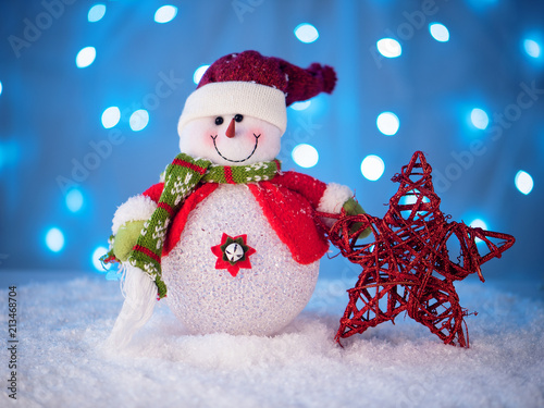 little snowman toy on a New Year's backgrou photo