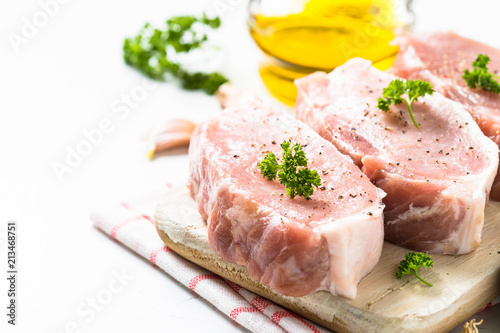 Pork meat steak on white top view. 