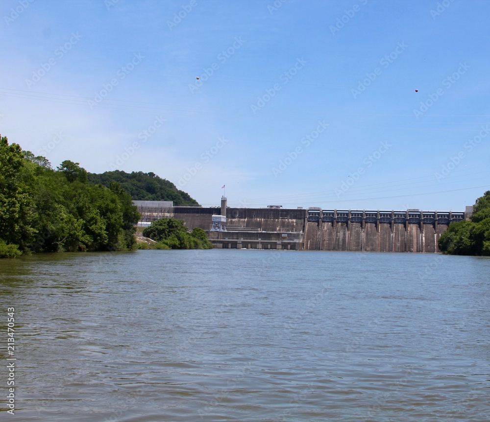 A view of the large dam structure from the middle of lake.
