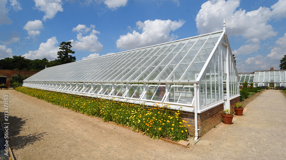 Historic restored Greenhouse with flowers .
