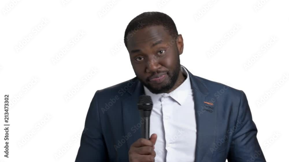 Portrait of young black man with microphone. Singing and dancing afro american man against white background. Portrait of young black man with microphone. Singing and dancing afro american man against white background.