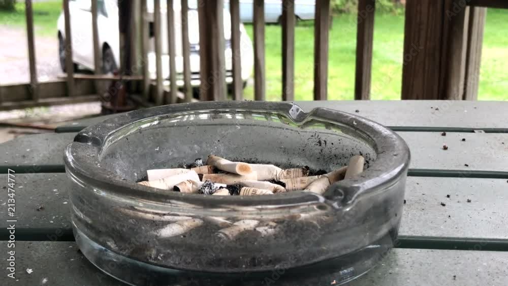 Ash Tray containing cigarette butts Ash Tray containing cigarette butts