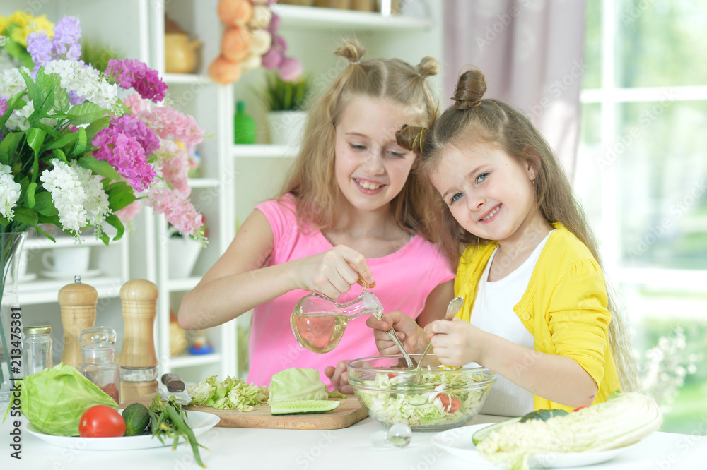 Cute girls preparing delicious fresh salad