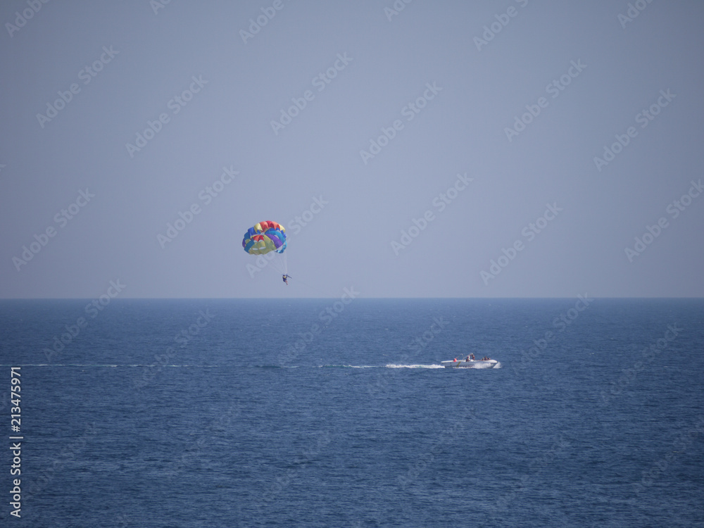color parachute stretched to a boat rope, entertainment for tourists at sea color parachute stretched to a boat rope, entertainment for tourists at sea