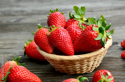 Colorful of fresh Strawberry in the basket on wooden background.