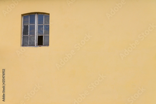 Window with a yellow wall, background for placing text © Vladyslav