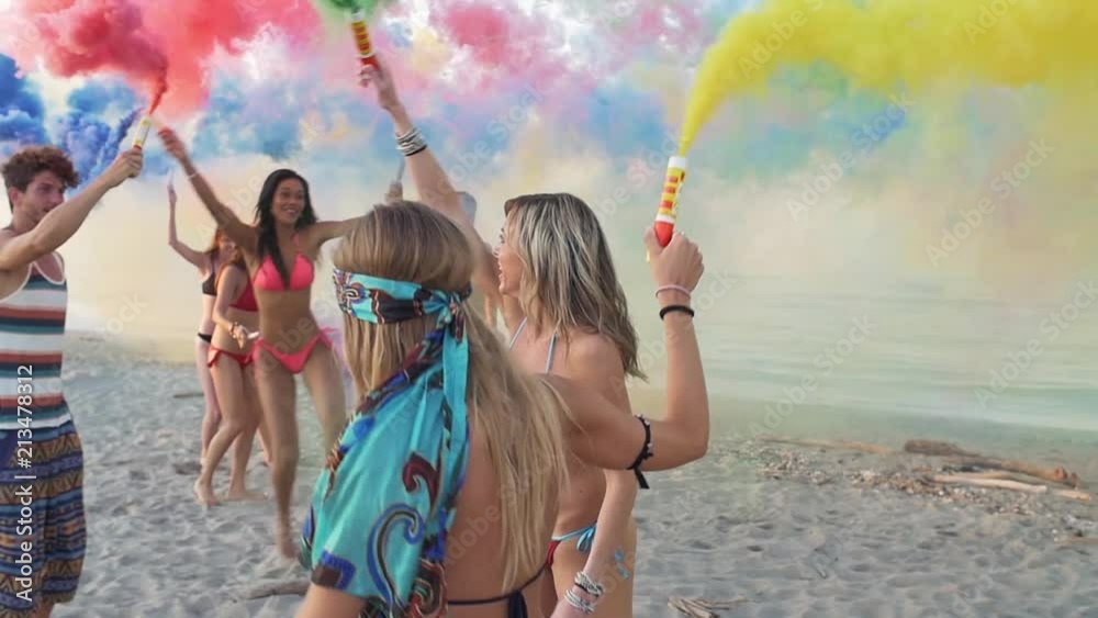 Group of friends making party on the beach