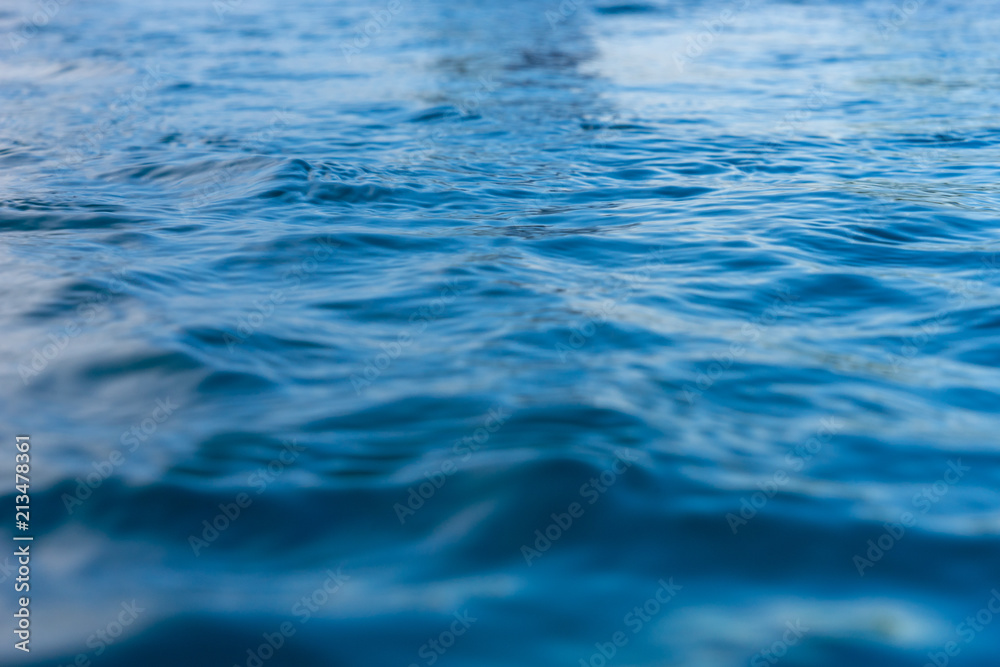 Reflection of blue water surface with small waves