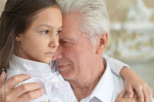 sad grandfather and granddaughter