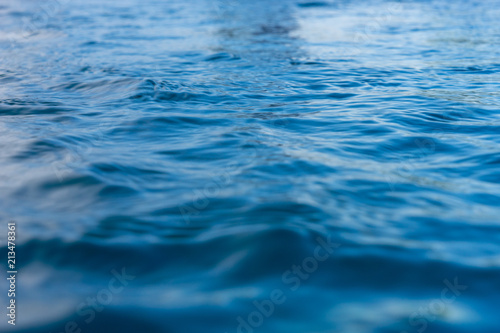 Reflection of blue water surface with small waves