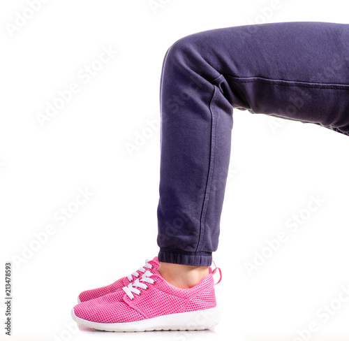 Female legs sport pants sneakers sport exercises on a white background isolation