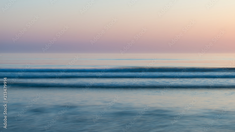 Beautiful colorful vibrant sunrise over low tide beach landscape peaceful scene
