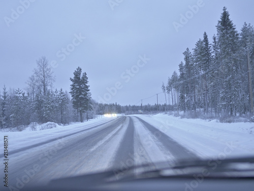 Winter driving on a frozen and slippery highway in Finland. © jarnicek
