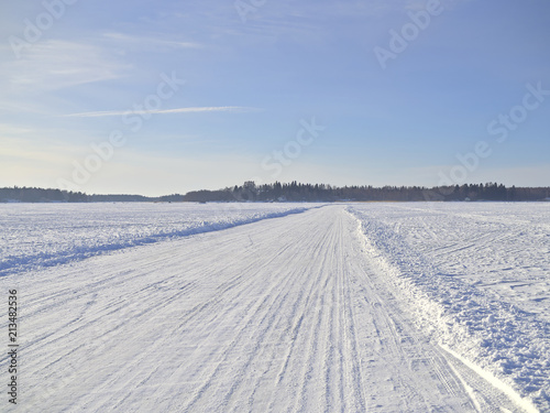 Ice road on frozen snow covered sea in Finland.
