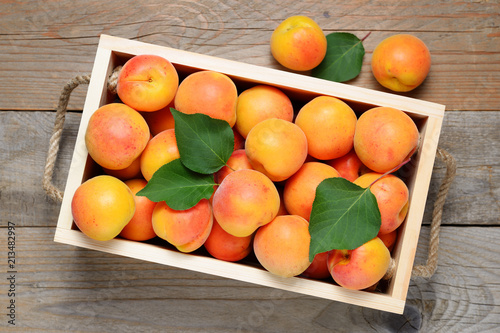 Apricots in wooden box top view