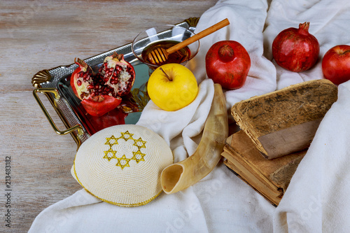 Honey, apple and pomegranate for traditional holiday symbols rosh hashanah jewesh holiday on wooden background. photo