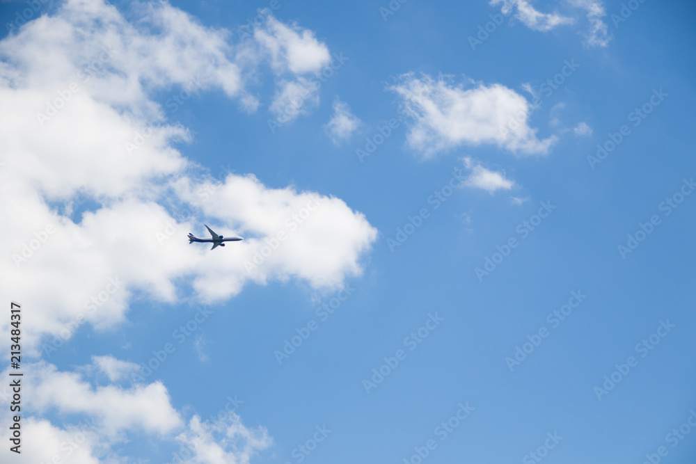 Image of flying airplane in clear sky with sun at background Image of flying airplane in clear sky with sun at background