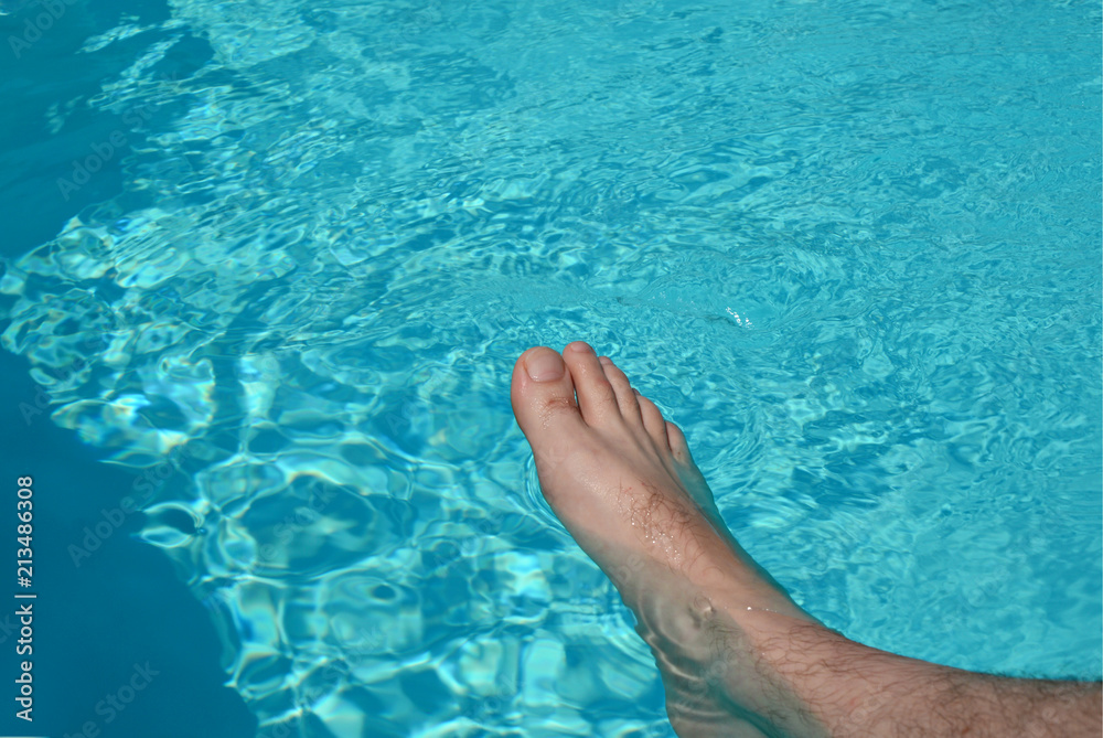 Man feet at the swimming pool.