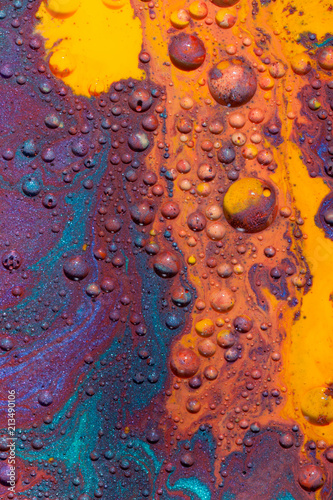 Mars-like landscape created with several paints on Glycerine which are forming little colorful balls and isles