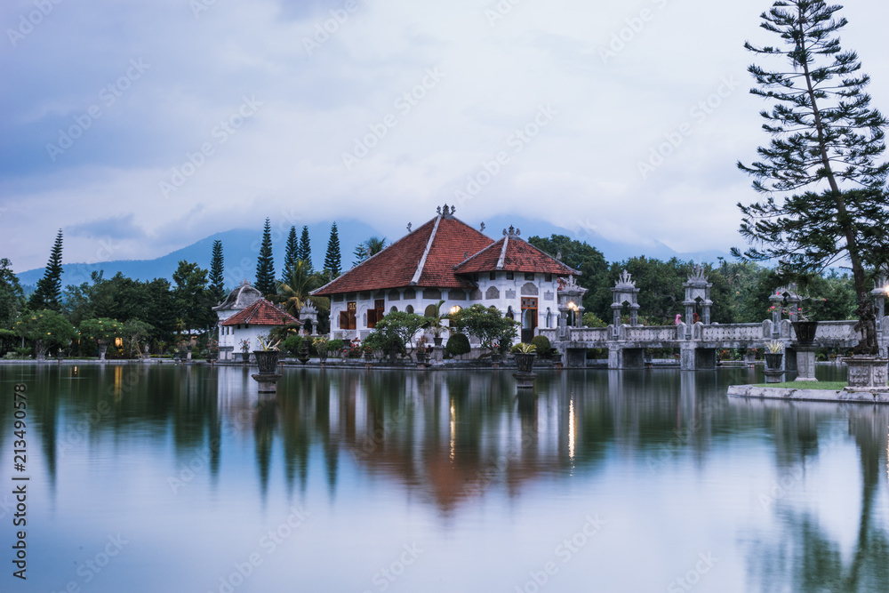 Bali, Indonesia: Panoramic view of building on lake shore with reflection in water Bali, Indonesia: Panoramic view of building on lake shore with reflection in water
