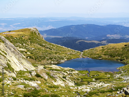 Fototapeta Naklejka Na Ścianę i Meble -  Elevated view to the Lake Upper Chanak, Rila Mountains, Bulgaria, the concentric circles of the ritual dance of the White Brotherhood members in the distance