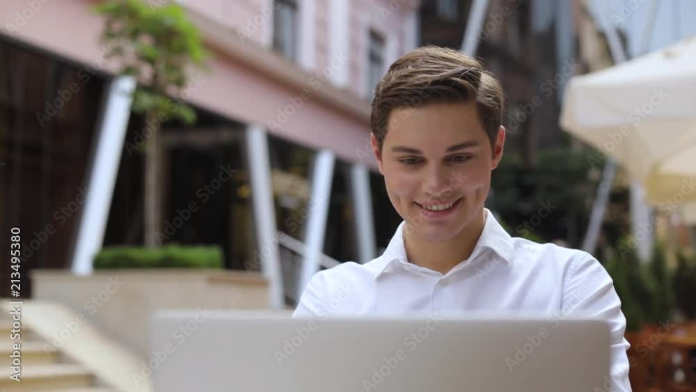 Smile attractive man use of laptop computer at outdoor near business ...